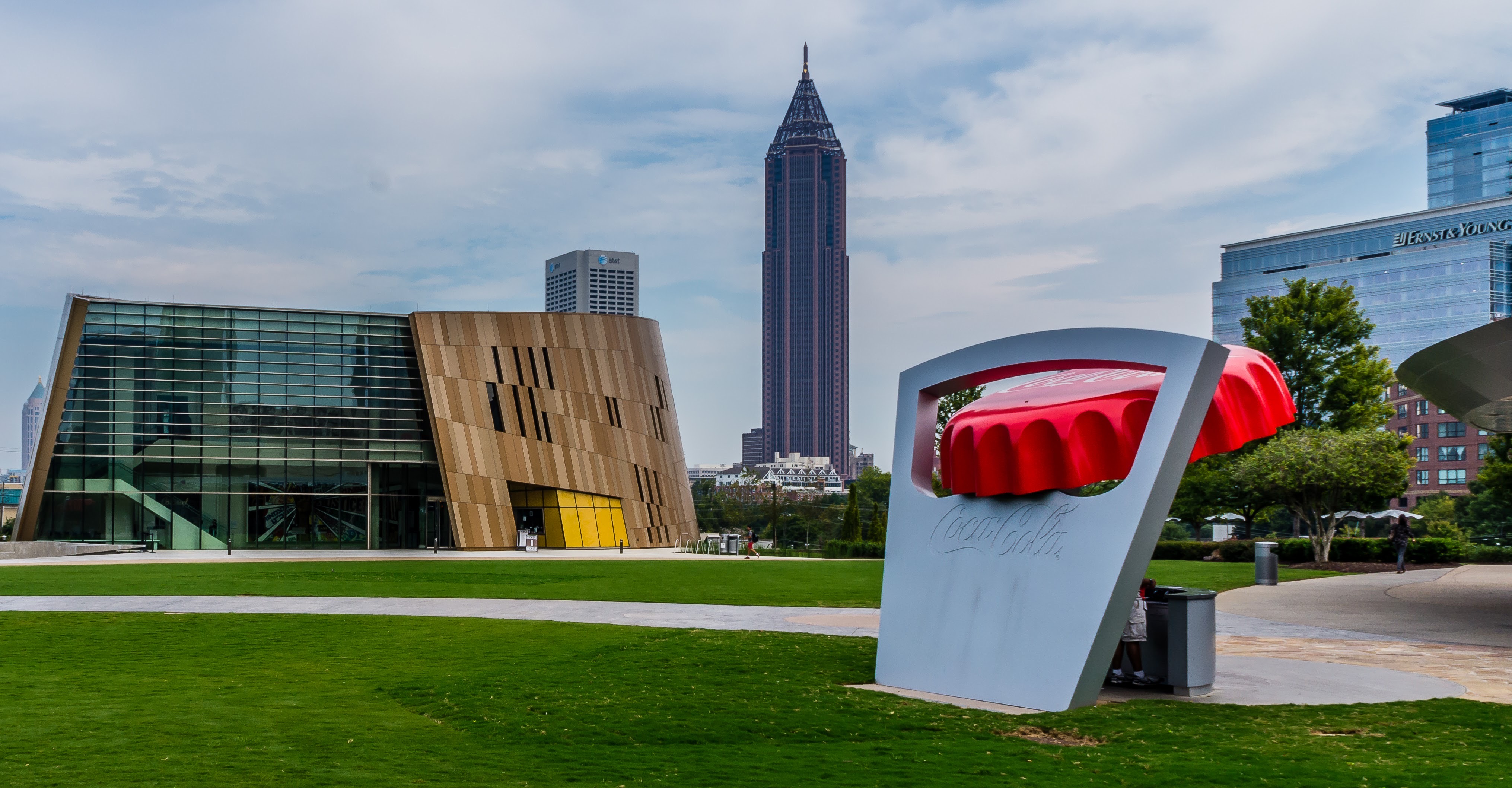 A green lawn and modern building on Georgia State's downtown Atlanta campus, with the city skyline in the background